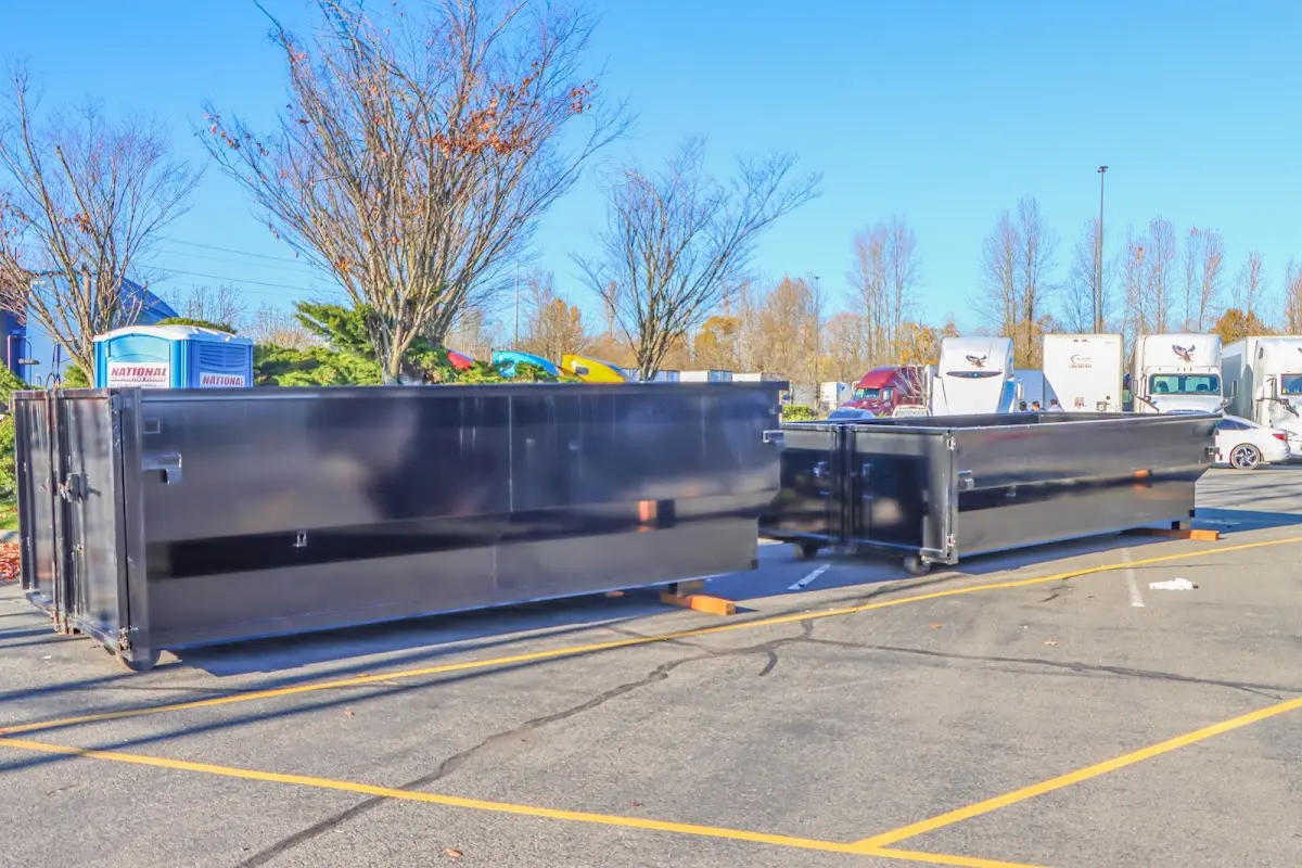 Professional dumpster rental service with roll-off container on residential driveway in Wilson